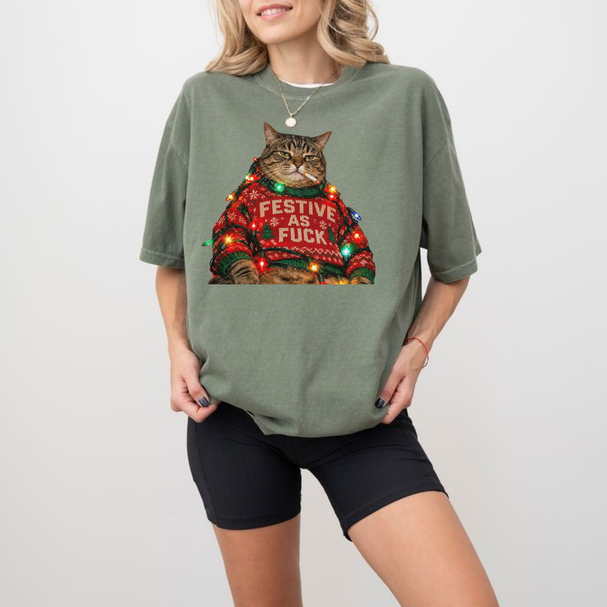 Front view of the festive friction tee displaying retro funny smoking Christmas cat graphic artwork across the chest of a garment-dyed shirt. - hiyamart