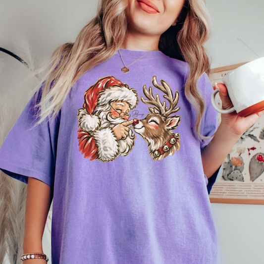 Front view of the Comfort Colors Santa & Reindeer Christmas T-Shirt displaying retro North Pole graphics across the chest of a garment-dyed tee. - hiyamart