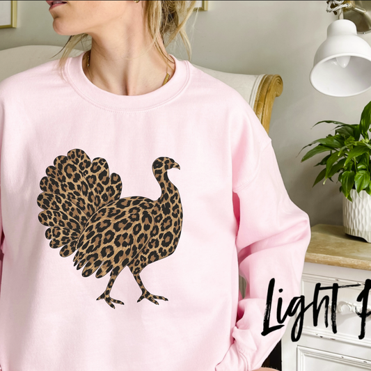 Front view of the Leopard Turkey Graphic Sweatshirt displaying leopard print turkey artwork printed across the chest of a cozy fleece crewneck. - hiyamart