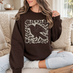 Front view of the parke horizon sweatshirt displaying gothic raven linocut style graphic artwork across the chest of a soft fleece crewneck pullover. - hiyamart