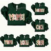 Front view of the yule pine heritage crewneck displaying personalized family name gingerbread plaid graphic artwork across the chest of a forest green sweatshirt. - dogmomhat